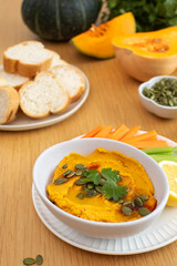 Pumpkin hummus and fresh vegetables for healthy eating. Autumn flavors.
