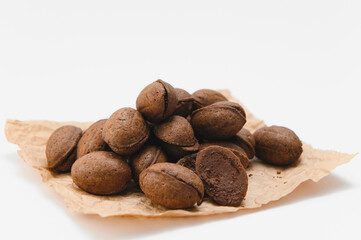 Delicious nut shaped cookies with boiled condensed milk on white background
