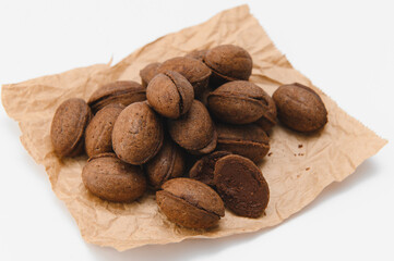 Delicious nut shaped cookies with boiled condensed milk on white background