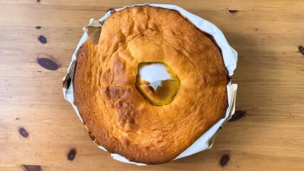 Golden sponge cake, whimsical crater center, evokes rustic Bellaria Festival vibes, culinary...