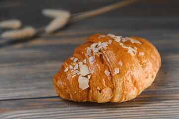 fresh baked croissant isolated on a wooden background