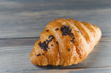 fresh croissant on a wooden background