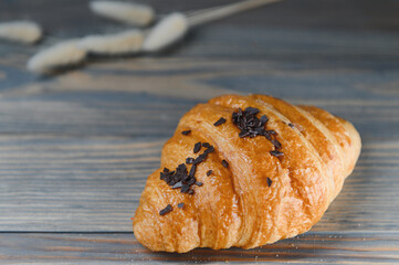 fresh baked croissant isolated on a wooden background