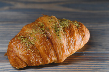 fresh croissant on a wooden background