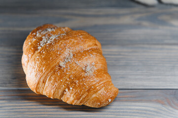 fresh croissant on a wooden background