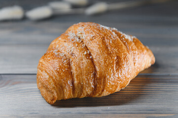 fresh croissant on a wooden background