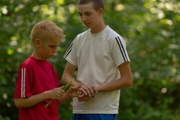Two young boys are standing right next to each other, curiously looking at something interesting...
