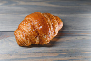 fresh croissant on a wooden background