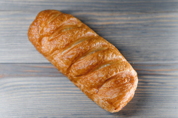 Sausage in dough . on a wooden background
