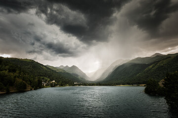 Dark storm clouds and rain gather over the Genos-Loudenvielle lake in the French Pyrenees