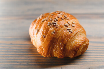 fresh baked croissant isolated on a wooden background