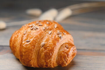 fresh baked croissant isolated on a wooden background