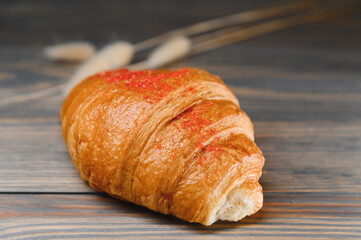 fresh croissant on a wooden background