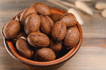 Delicious nut shaped cookies with boiled condensed milk on a wooden background