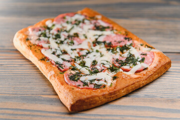 Tasty mini pizza on a wooden background