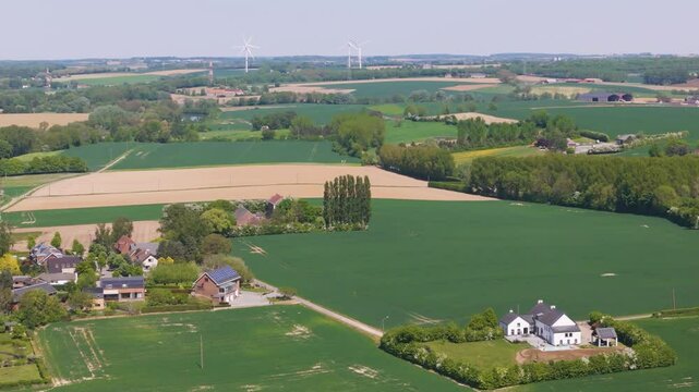 seneffe town surrounding areas green fields small houses distant windmills create charming rural scene reflecting town's from right to left pans aerial drone belgium 