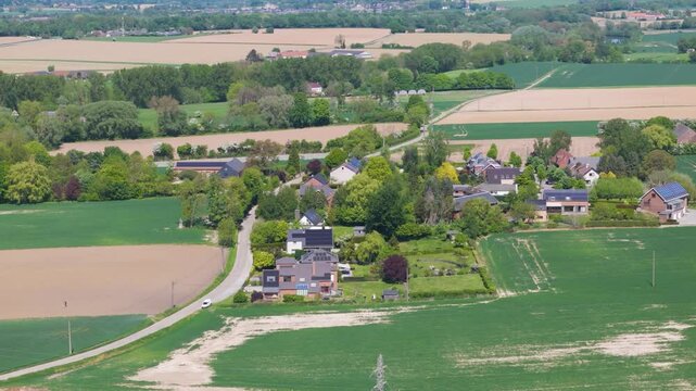 seneffe town surrounding areas scene green fields small houses windmills distance beautiful homes from left to right pans aerial belgium inviting atmosphere scenic outdoor engagement 