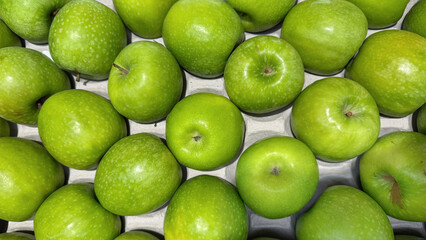 Freshly Harvested Green Apples Arranged Neatly on a Display for Sale at a Farmers Market