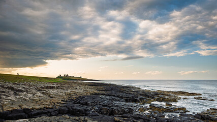 Big Sky above Dunstanburgh Castle.  The rocky shore between Craster Village and Dunstanburgh Castle is an ever changing tidal environment in Northumberlands National Landscape