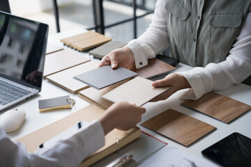 Interior designer presenting eco friendly wooden material samples for sustainable home decor