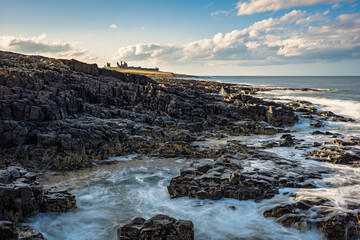 The rocky shore south of Dunstanburgh Castle.  The rocky shore between Craster Village and...