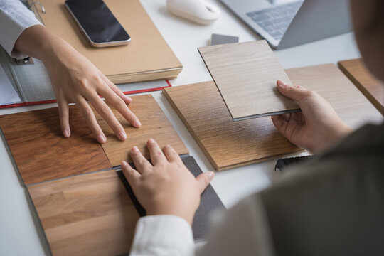 Interior designer presenting eco friendly wooden material samples for sustainable home decor