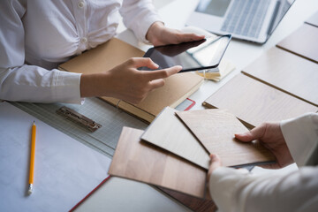 Client and interior designer selecting materials for home decoration in collaborative consultant