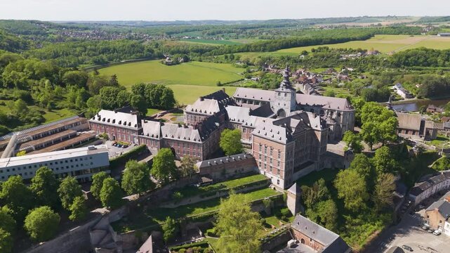 moves town's layout alongside floreffe abbey belgium perspective unique local architecture revealing from right to left circling aerial shot view town 