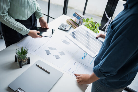 Solar panels green energy Business people working in green eco friendly office business meeting creative ideas for business eco friendly professional teaching corporate people sustainable electricity