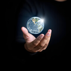Businessman presenting a rotating, glowing planet earth hovering over open hand, symbolizing global business, environmental awareness, and technological innovation