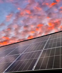 Solar panels producing renewable energy under a beautiful sunset