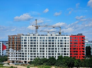 Aerial view of city residential area with high apartment buildings under construction. modern apartment buildings on the sunny day with a blue sky. modern urban apartment apartment building