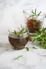 Homemade rosemary tulsi oil for hair growth, selective focus