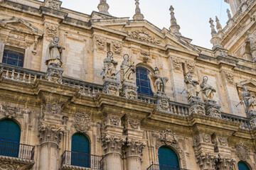 Intricate stone carvings of historic figures adorn the facade of Santa Iglesia Catedral in Jaen,...