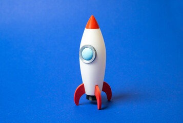 Space rocket on blue background. Concept of space aerotechnics. Advertising, startups. Advanced...