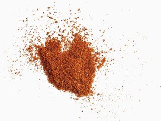 Sprinkle of chopped hot red chili peppers or paprika, paprika or red chili powder isolated on white background. Dry paprika powder spice. Pile of crushed red chili peppers or paprika.