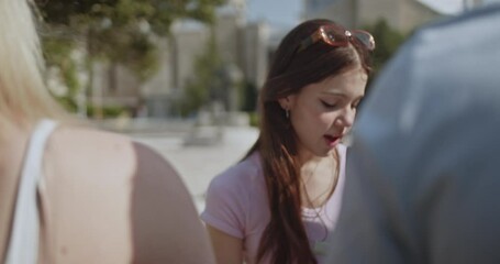 Young female students intently engage in group study and discussion on a sunny university campus. Their collaborative learning fosters intellectual growth and prepares them for future academic success - Powered by Adobe