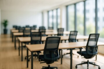 Fototapeta premium Sunlit Modern Office Interior with Rows of Empty Desks and Chairs in Bright Spacious Room with Large Windows