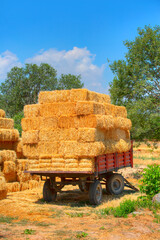 A stack of square hay bales on a tractor trailer 