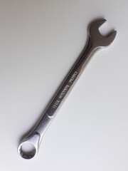 A ring spanner, also known as a combination wrench, isolated on a white background.