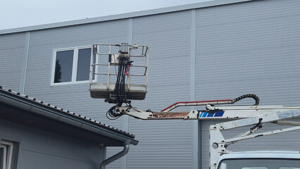 aerial platform cradle against the background of the enterprise's workshops