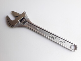 A wrench, also known as an adjustable wrench, is shown on a white background. It is a versatile tool designed for tightening or loosening bolts or nuts with adjustable jaws.