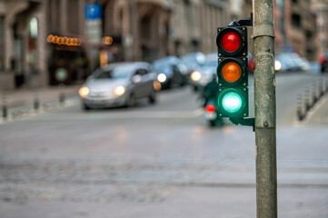 traffic light on the street junction with beautiful bokeh, city with cars in the background
