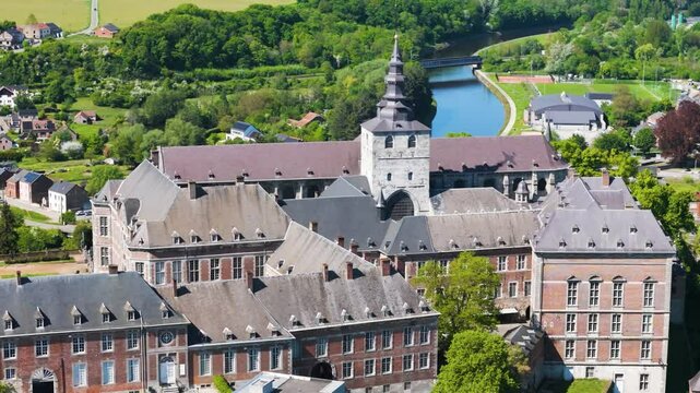 moves main building floreffe abbey belgium sombre river background green cover enhance from left to right close up panning shot view close-up abbaye de 