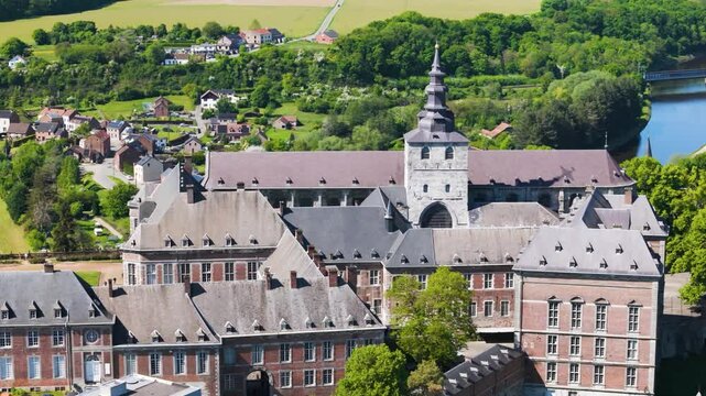 main building floreffe abbey belgium sombre river town background green cover fields add to scenery reveals left right close up panning shot close-up 