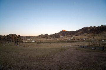 Mongolian Landscape at Dawn with Village and Mountains