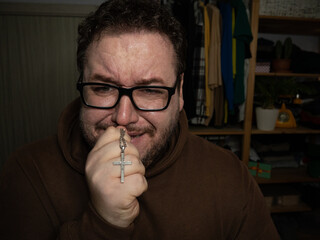 A grown man hopes for a miracle and prays.
