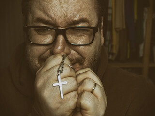 A grown man hopes for a miracle and prays.