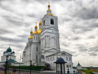The historic cathedral, adorned with shimmering golden domes, stands majestically against a...