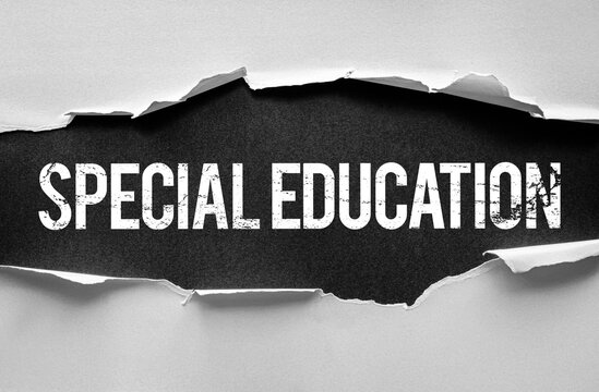 Word "SPECIAL EDUCATION" revealed under torn paper. Concept for inclusive learning, educational support, disability services, or adapted teaching. White bold text on dark background